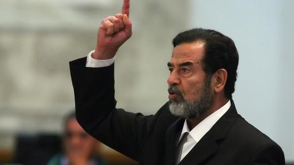 Baghdad, IRAQ: Former Iraqi President Saddam Hussein yells at the court as he receives his verdict during his trial held under tight security in Baghdad's heavily fortified Green Zone, 05 November 2006. Saddam was sentenced to death for his role in the killing in 1982 of nearly 150 people in the mainly Shiite village of Dujail, north of Baghdad, after a failed attempt on the former dictator's life. AFP PHOTO/POOL/SCOTT NELSON (Photo credit should read SCOTT NELSON/AFP/Getty Images)